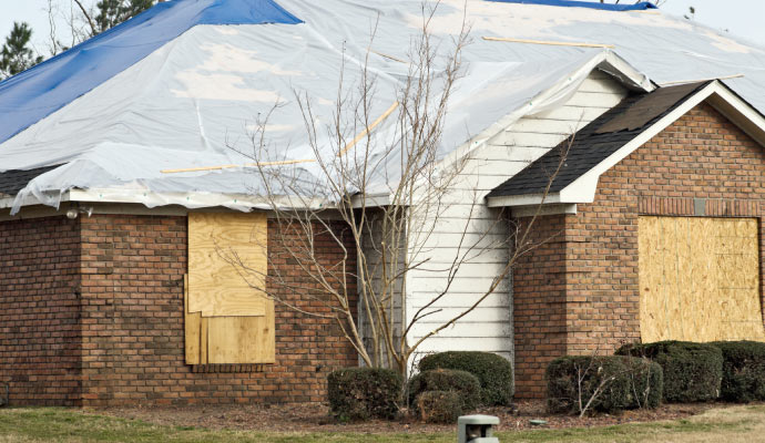 Boarded up damaged house