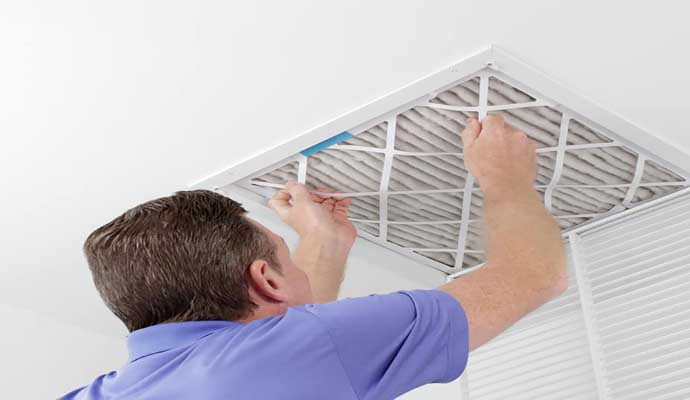 person cleaning duct