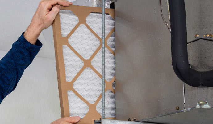 professional worker replacing HVAC filter