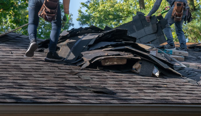 Person repairing the damaged roof