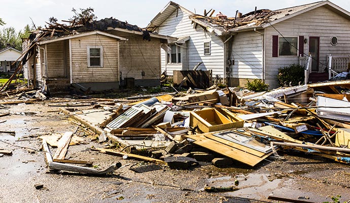 Tornado damaged homes with debris scattered around