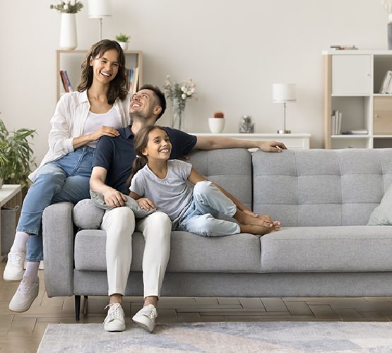A happy family relaxing on a sofa A happy family relaxing on a sofa